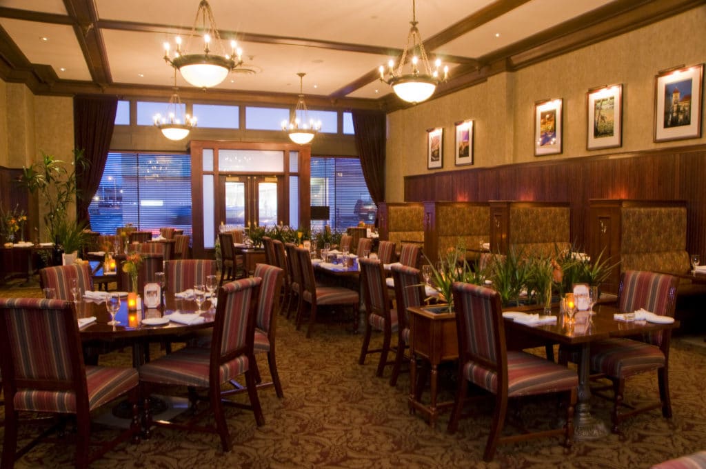 restaurant of the Marcus Whitman hotel, elegant booths and tables, box-beam ceiling, rich textured walls