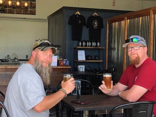 Two guys enjoying a beer