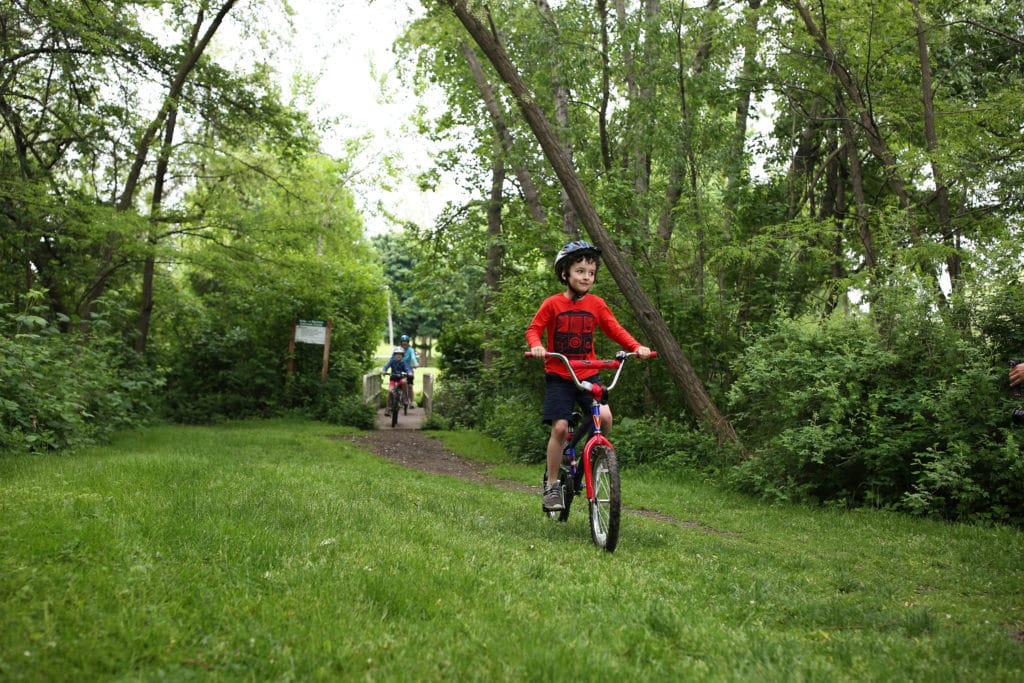 Boy riding bike in park
