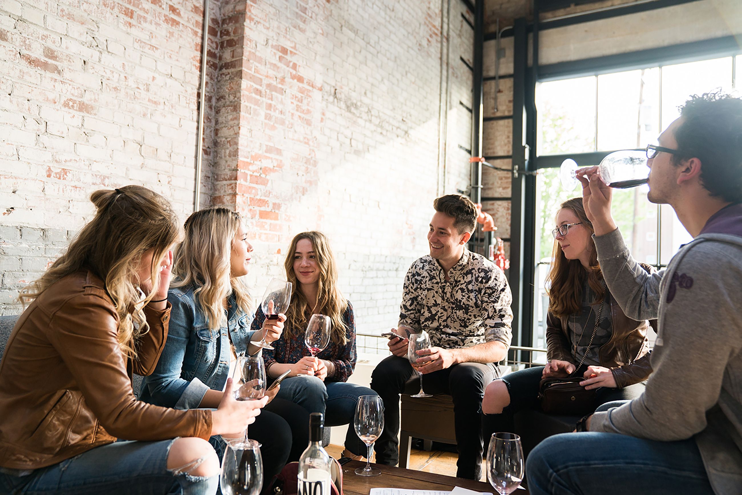 Group of people at venue sitting down drinking wine