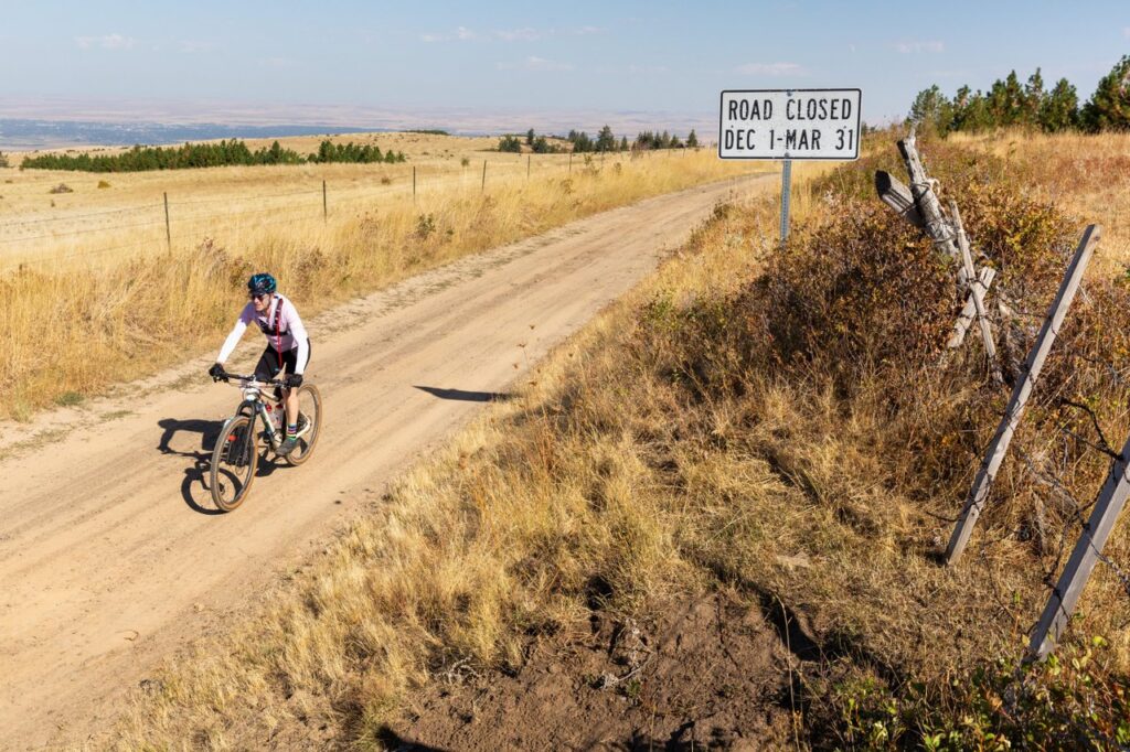 A dusty bike trail in the middle of a wheat field with a sign that says "Road Closed Dec 1-Mar 31"