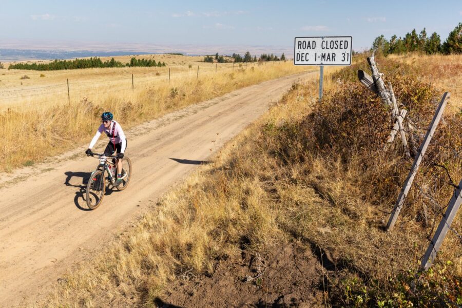 A dusty bike trail in the middle of a wheat field with a sign that says "Road Closed Dec 1-Mar 31"