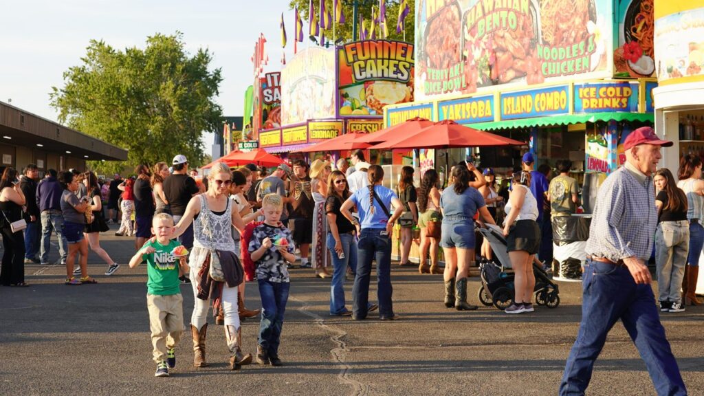 WW Fair & Frontier Days family walking by food vendors
