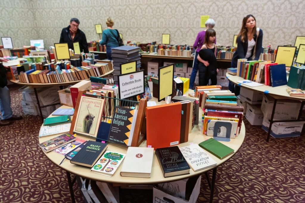 AAUW Book Sale round table filled with books