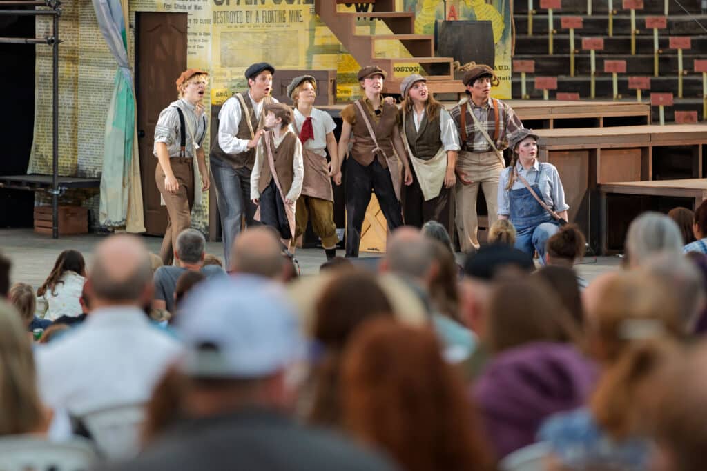 Newsies cast on stage